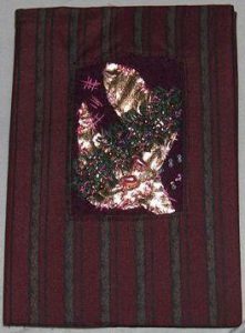 Bogomslag med broderi på uld