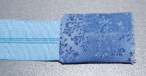 Forlæng din lynlås ved at sy ender på.